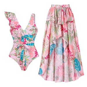 Flat lay of ruffle shoulder floral swimsuit and matching high-low asymmetrical skirt
