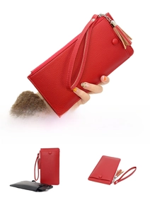 Detailed view of red long wallet with lychee pattern leather and fringe tassel decoration