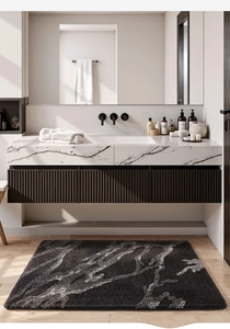 Detail view of plush marble pattern bath mat in a modern bathroom interior