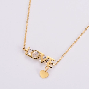 Golden LOVE letter pendant necklace with sparkling zircons and a small heart charm