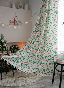 Detail of Christmas curtain with green holly leaves, red berries and plaid bell patterns