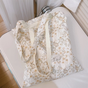 Detail of floral rabbit canvas tote bag showing artistic print and woven texture