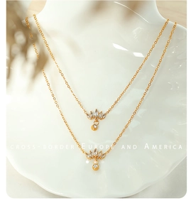 Detailed macro view of 18K gold plated zircon pendant necklace with crystal lotus charm