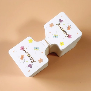 Macro shot of bifold paper display cards with floral prints for hair accessories
