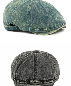 Detail van gewassen denim krantenjongenspet met vintage textuur en metalen gesp