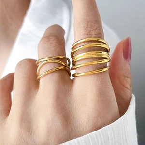 Detail showing two gold layered rings with multi-row intertwined and parallel band designs