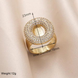 Detail view showing 23mm diameter gold ring face with micro-paved clear cubic zirconia stones