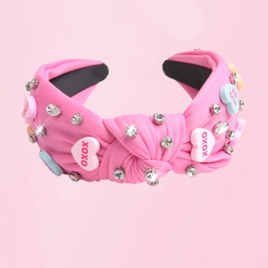 Pink knotted fabric headband with shiny rhinestones and colorful heart candy accessories