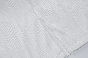 Detail view of white vertical pleated fabric with high-quality stitching and rib texture