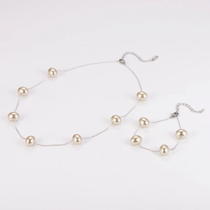 Detail of elegant champagne pearl necklace and bracelet set with silver chain links
