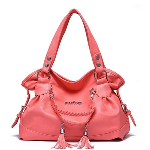 Pink soft leather tote bag with tassels and metallic ring accents on white background