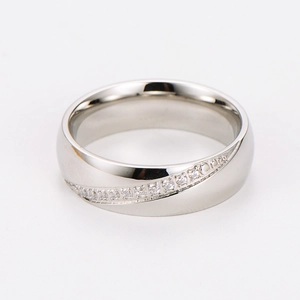 Macro detail of silver stainless steel ring with diagonal pavé cubic zirconia setting