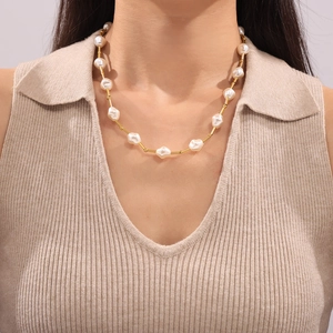 French vintage pearl and 18k gold plated titanium steel necklace on a model