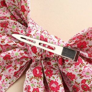 Floral print cotton bow hair clip with pink flowers and a silver metal duckbill clip