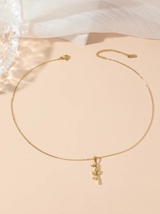 Detailed macro view of a 3D rose pendant on a golden stainless steel chain necklace