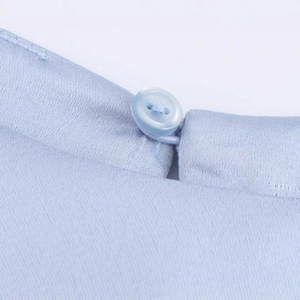 Light blue satin dress featuring a round neckline with a single button closure detail