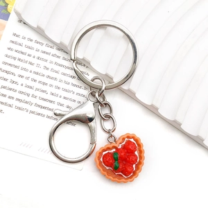 Creative strawberry tart heart resin keychain with silver lobster clasp on white tray