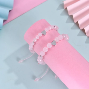 Pink zebra stone bead bracelets with silver heart pendants on display