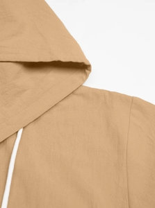 Close-up of khaki cotton-linen hooded shirt showing neck details and fabric texture