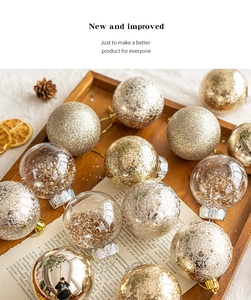 Assorted gold and silver Christmas ornaments on a wooden tray with pine cones and dried oranges