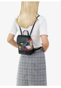 Detail of drawstring bucket backpack with color-block diamond pattern and gold turn-lock