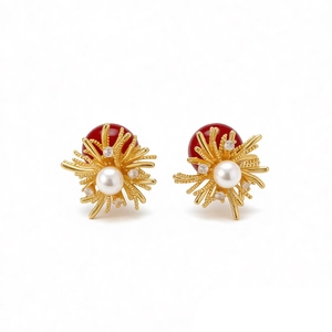 Elegant gold earrings with red resin bead, white pearl, and zircon firework design