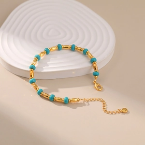 Close-up of vintage turquoise bead bracelet with gold accents and lobster clasp
