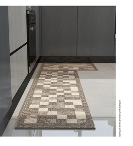 Detail of beige and grey checkered kitchen mats with non-slip texture on tile floor