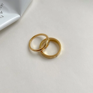 Star and moon gold ring set with cubic zirconia and starburst engraving details