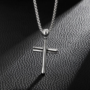 Detail of silver baseball bat cross pendant with smooth metallic finish on black leather