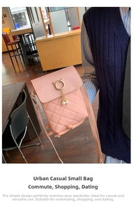 Detail of pink quilted crossbody bag featuring golden cat ears and pearl charms