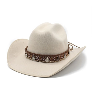 Detail of beige western cowboy hat featuring ethnic woven band and silver coin accents