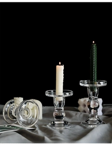 Close-up of vintage glass candlesticks on elegant grey satin with honeycomb taper candles
