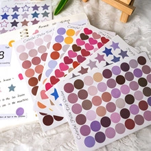 Close-up of Morandi colorful heart and star stickers on a soft white plush surface