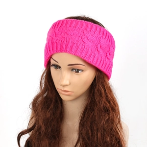 Detail of hot pink cable knit winter headband showing thick texture and warm braided pattern