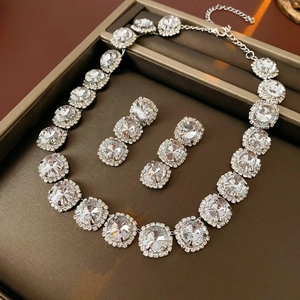 Detailed view of zircon water drop pendant necklace and earrings set on jewelry tray