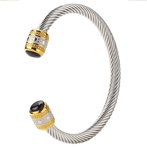 Two-tone gold and silver twisted cable cuff bracelet with black onyx end caps