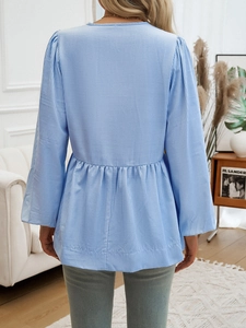 Back view of striped blouse with puff sleeves and tie waist detail in blue and white