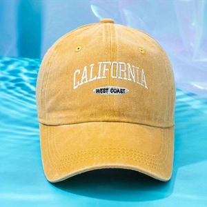 Detailed embroidery of CALIFORNIA WEST COAST on a vintage yellow washed cotton cap