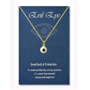 Macro detail of golden stainless steel chain with a classic evil eye amulet pendant