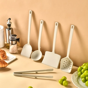 Five-piece cream white silicone kitchen utensil set with non-stick spatulas and food tongs