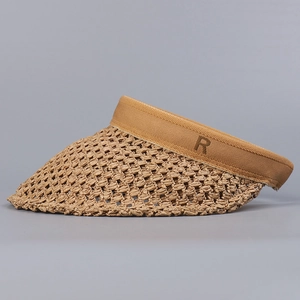 Detail of hand-woven straw visor featuring embroidered letter R on the brown side band
