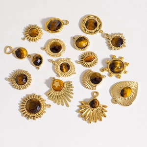 Golden tiger eye stone charms in various geometric shapes on a clean white background