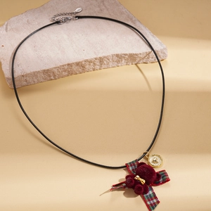 Vintage teddy bear necklace with burgundy flocking and plaid bow pendant