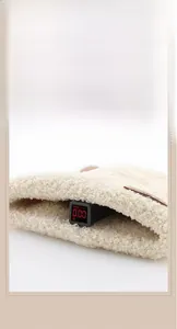 Detail of plush baby hat fabric showing a safety test reading 0.00 for non-toxicity