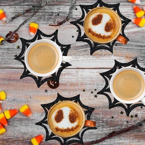 Halloween black spider web coasters set of 4 on wooden table with candy corn decor