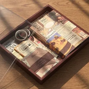 Vintage stationery gift set with wooden box, stickers and tapes on dark wood table