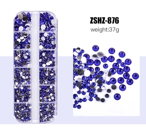 Detailed view of blue resin rhinestones in a 12-grid storage box for nail art DIY