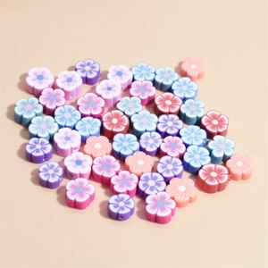 Detailed macro view of 10mm multi-colored polymer clay flower beads with threading holes