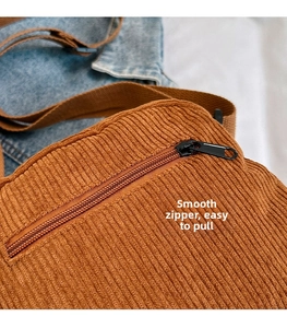 Close-up of caramel corduroy bag detail showing smooth nylon zipper and texture